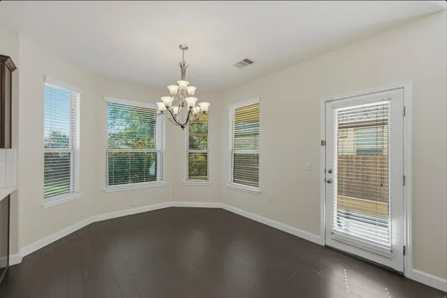 a kitchen with a sink refrigerator and cabinets