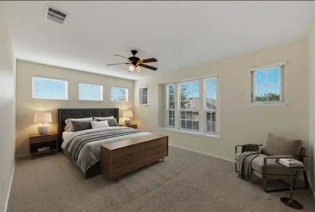 a bedroom with a bed and a couch