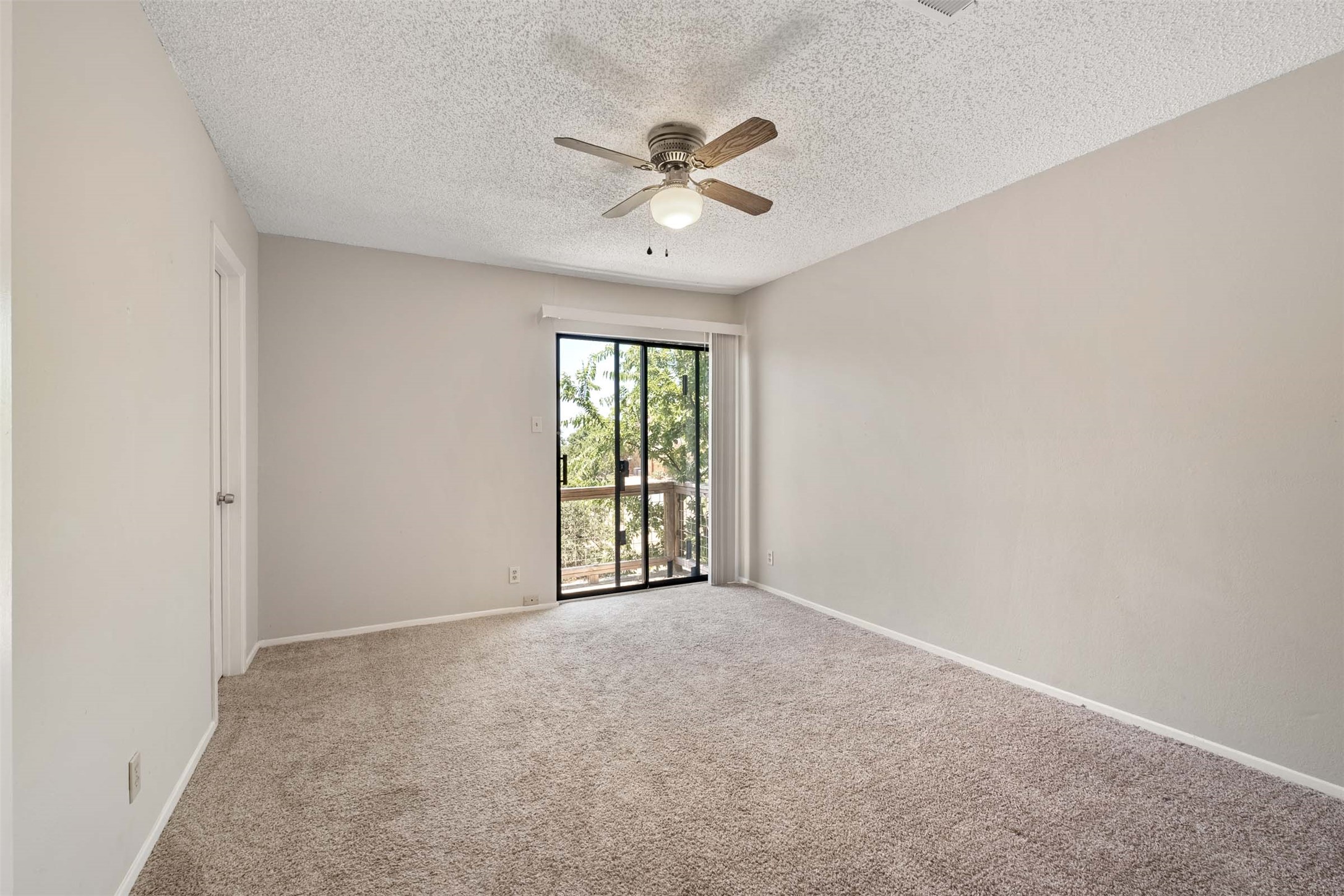 3904 Hudson Bend Road, Unit A Austin, TX 78734 - Photo 14 of 23 Unfurnished room with carpet flooring, a ceiling fan, and a textured ceiling