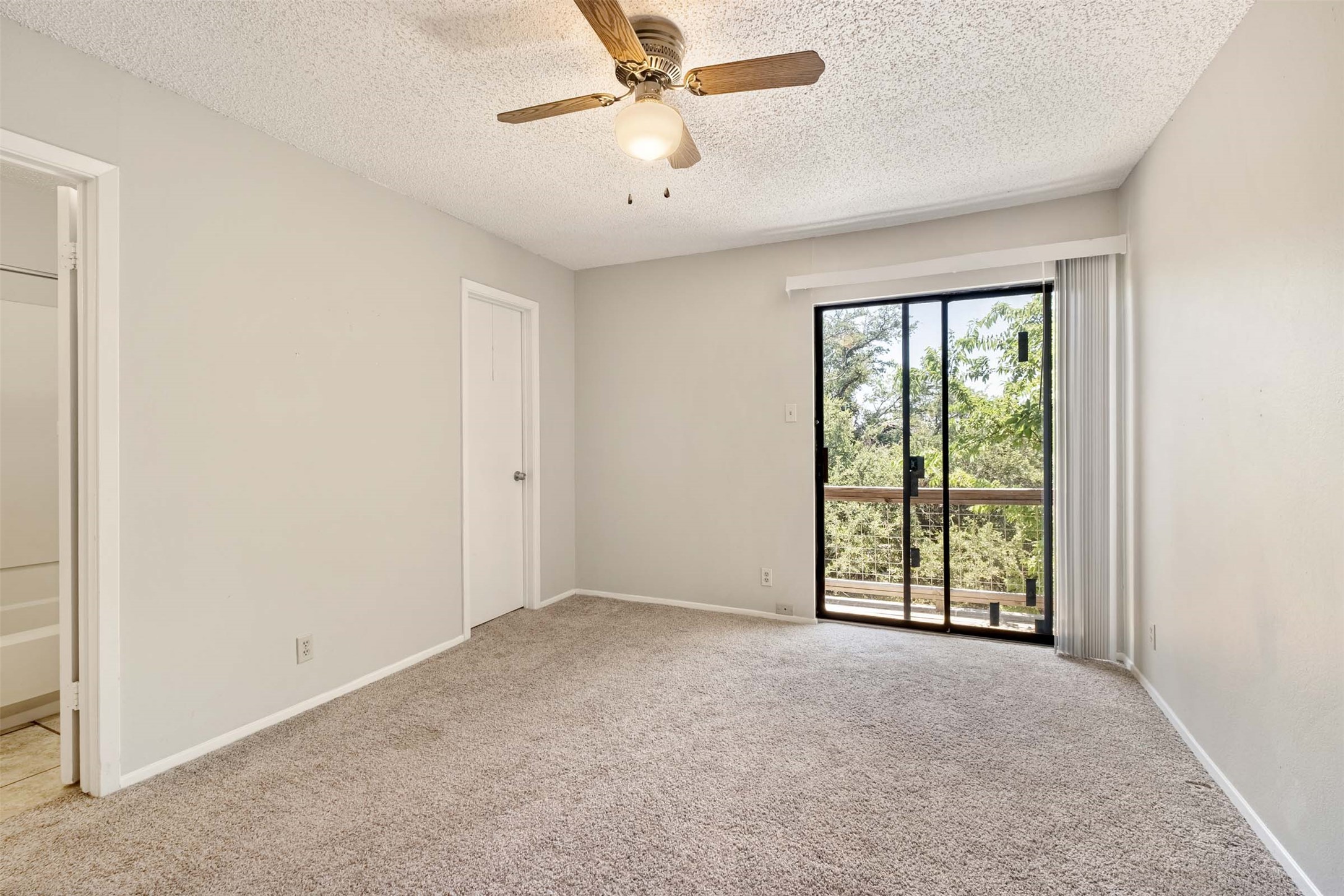 3904 Hudson Bend Road, Unit A Austin, TX 78734 - Photo 16 of 23 Unfurnished bedroom with light carpet, a ceiling fan, a textured ceiling, access to outside, and ensuite bathroom