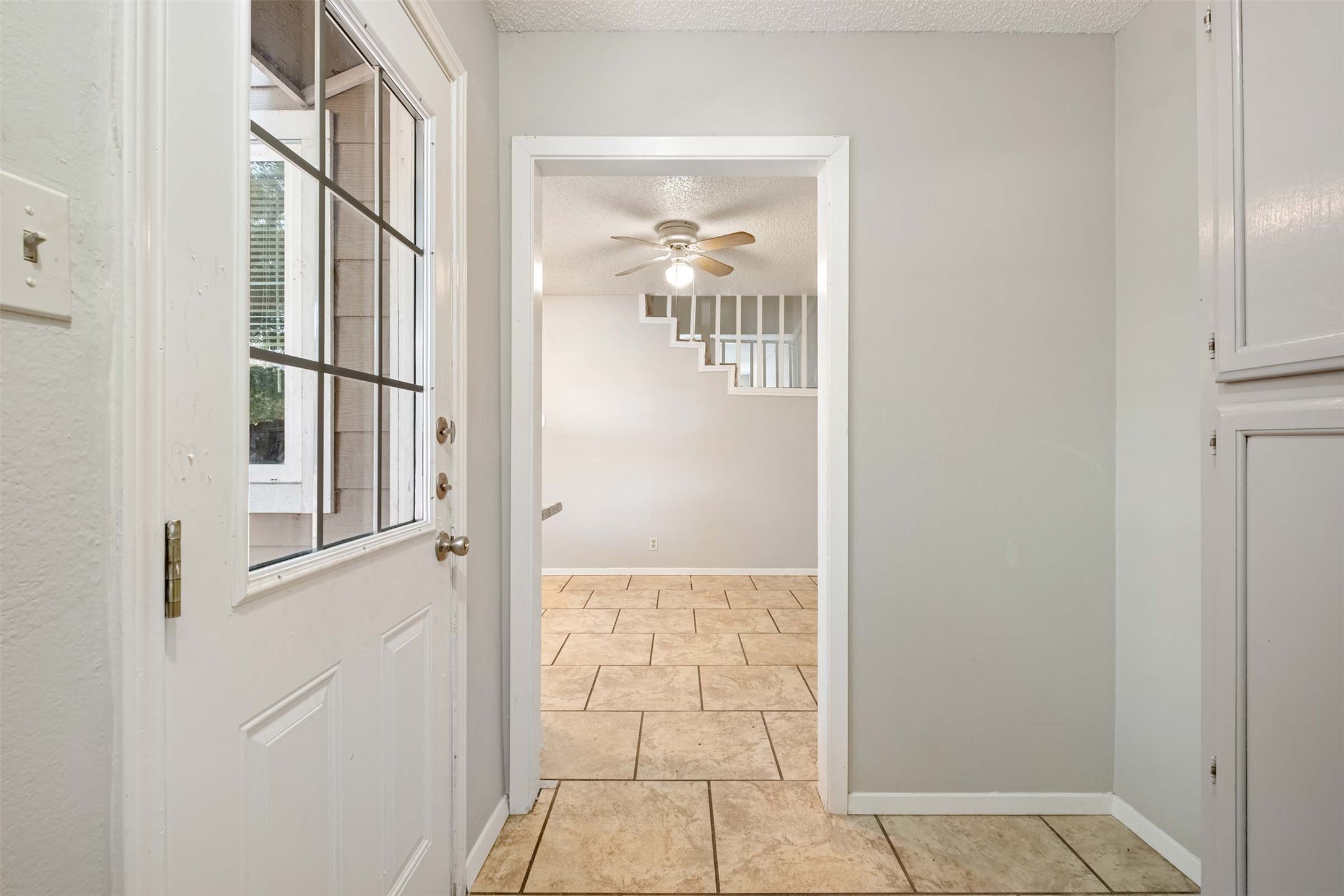 3904 Hudson Bend Road, Unit A Austin, TX 78734 - Photo 2 of 23 Entryway with a textured ceiling, ceiling fan, and tile patterned floors