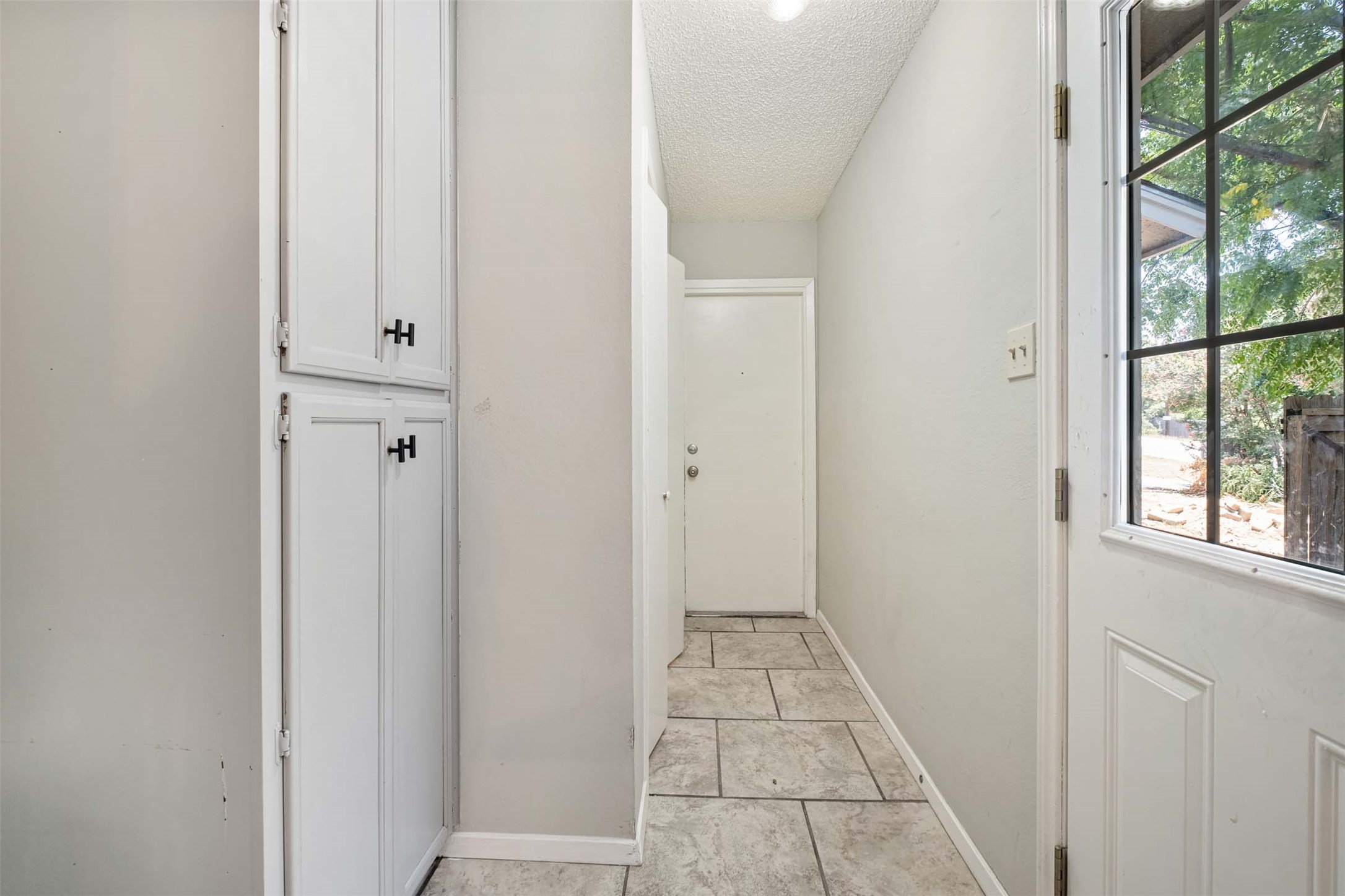3904 Hudson Bend Road, Unit A Austin, TX 78734 - Photo 3 of 23 Entryway featuring baseboards and a textured ceiling
