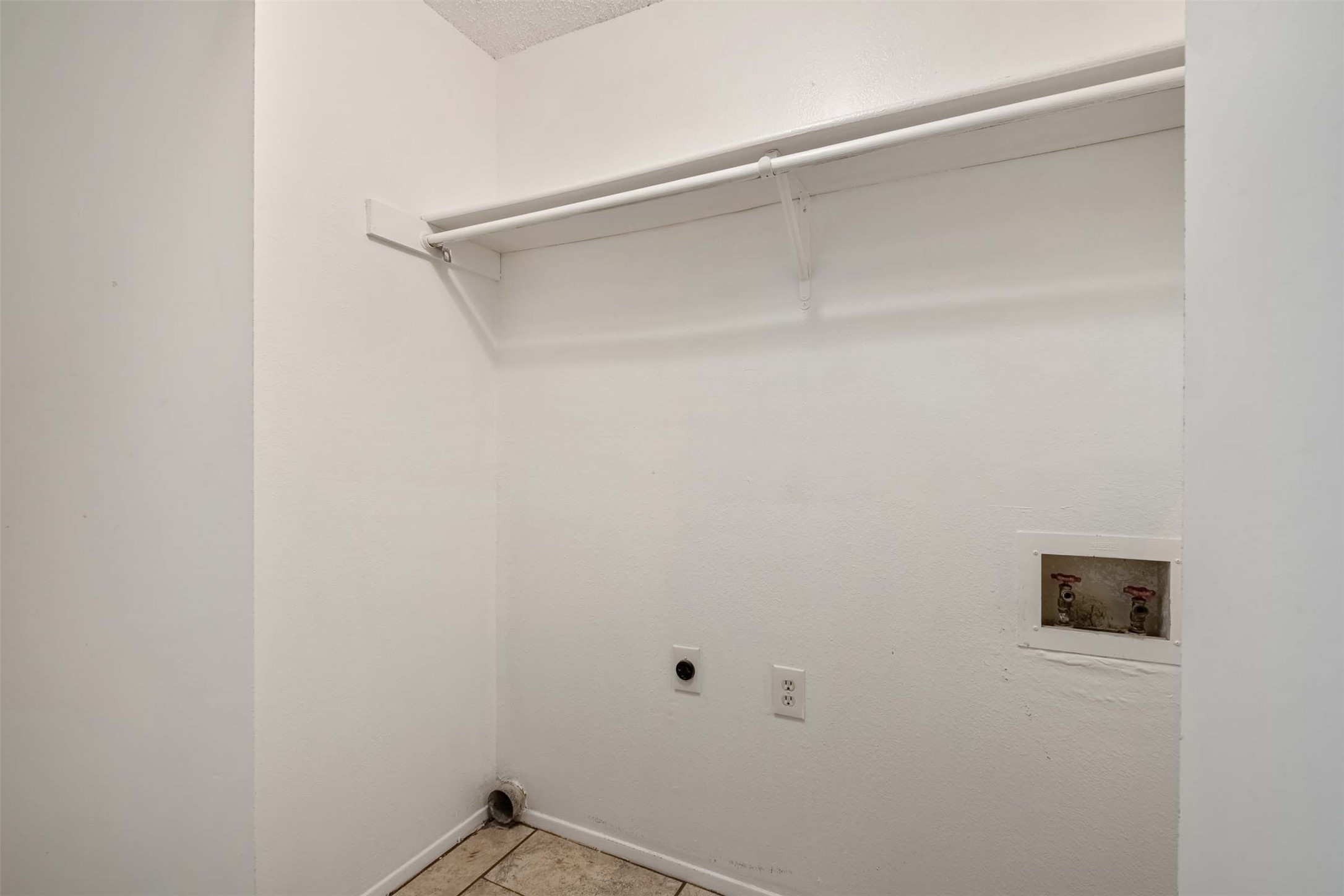 3904 Hudson Bend Road, Unit A Austin, TX 78734 - Photo 4 of 23 Laundry area featuring hookup for an electric dryer, washer hookup, a textured ceiling, and light tile patterned floors