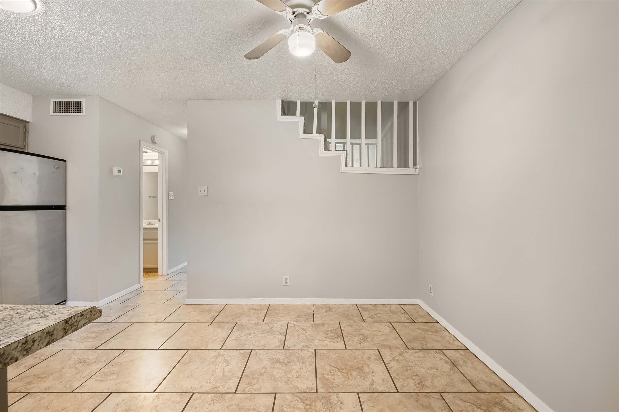3904 Hudson Bend Road, Unit A Austin, TX 78734 - Photo 5 of 23 Spare room with a textured ceiling and a ceiling fan