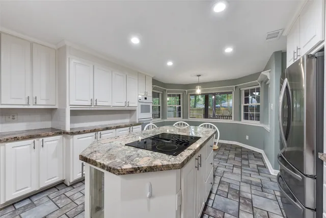 a kitchen with granite countertop a sink and cabinets