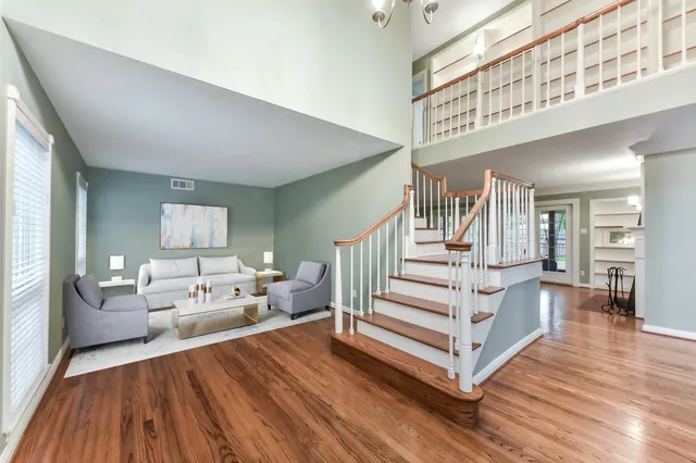 a view of entryway livingroom and hall with wooden floor