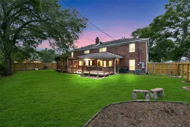 a view of a house with a backyard