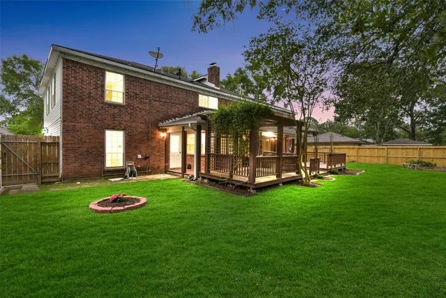 a view of a backyard with table and chairs and wooden fence