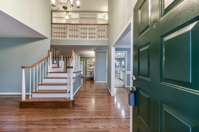 a view of entryway and hall with wooden floor