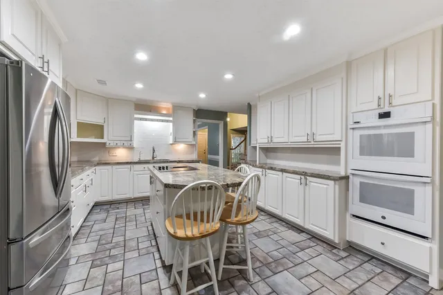 a kitchen with a sink appliances and cabinets