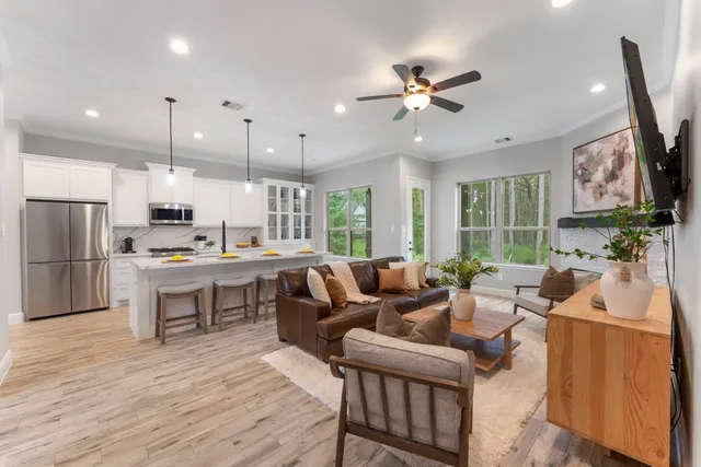 a living room with stainless steel appliances kitchen island granite countertop furniture and a view of kitchen