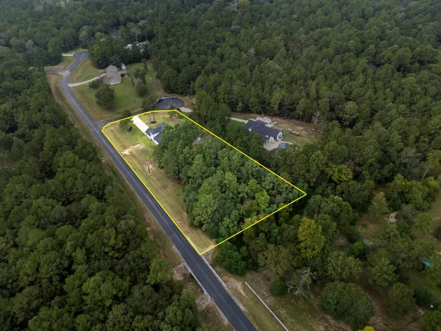 an aerial view of house with a yard