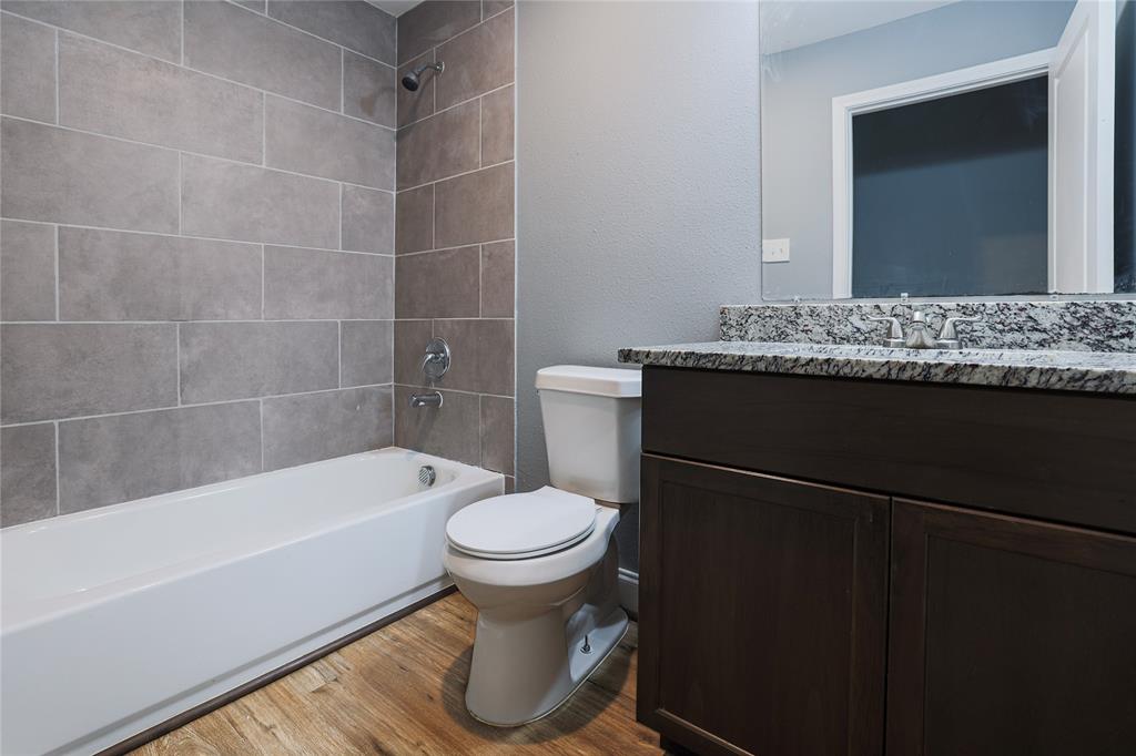 902 Cedar Street Commerce, TX 75428 - Photo 3 of 11 a bathroom with a sink toilet and shower