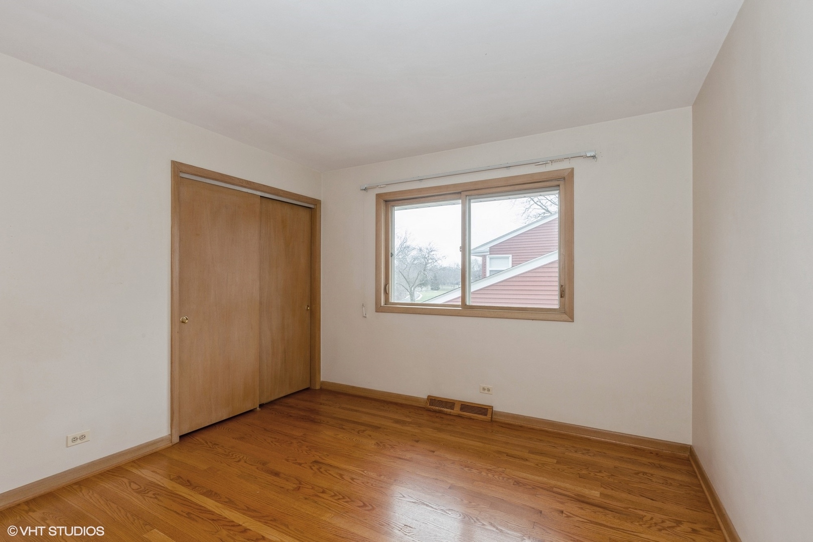 1330 South Main Street Wheaton, IL 60189 - Photo 11 of 19 a view of an empty room with wooden floor and a window