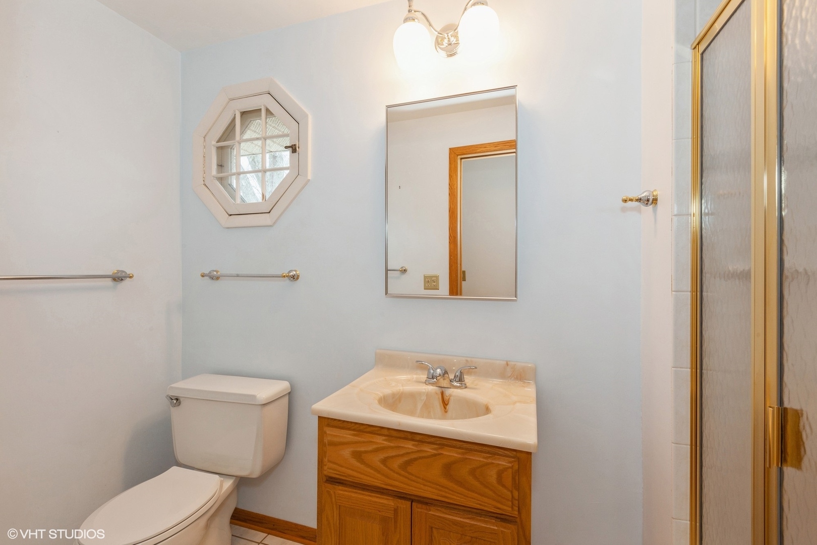 1330 South Main Street Wheaton, IL 60189 - Photo 12 of 19 a bathroom with a toilet sink vanity and mirror