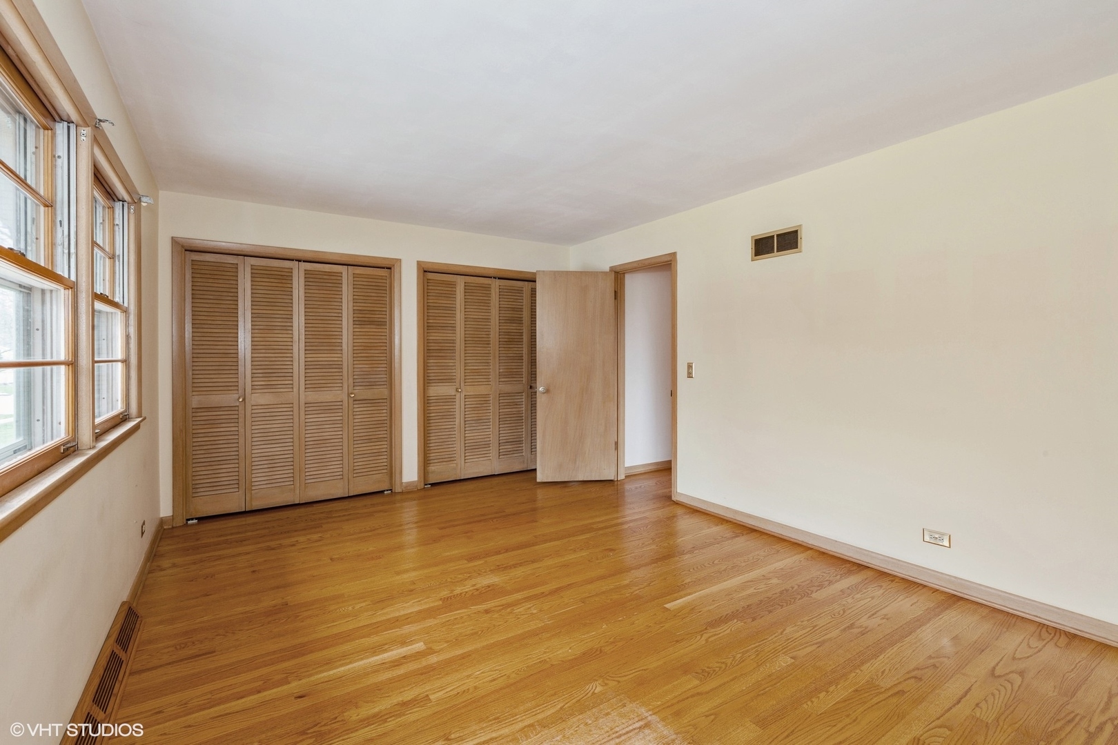 1330 South Main Street Wheaton, IL 60189 - Photo 13 of 19 an empty room with wooden floor and windows