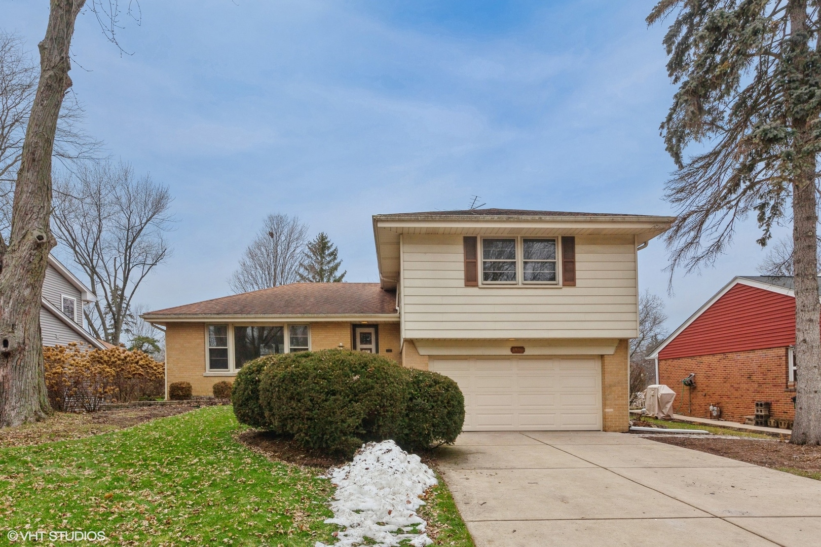 1330 South Main Street Wheaton, IL 60189 - Photo 2 of 19 a front view of a house with a garden