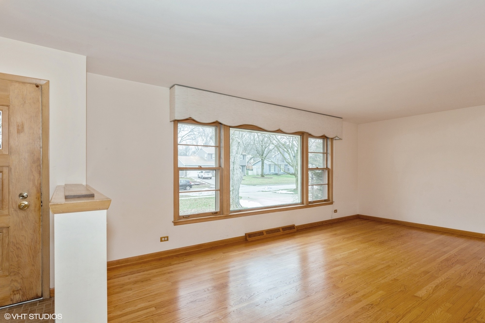 1330 South Main Street Wheaton, IL 60189 - Photo 3 of 19 an empty room with wooden floor and windows