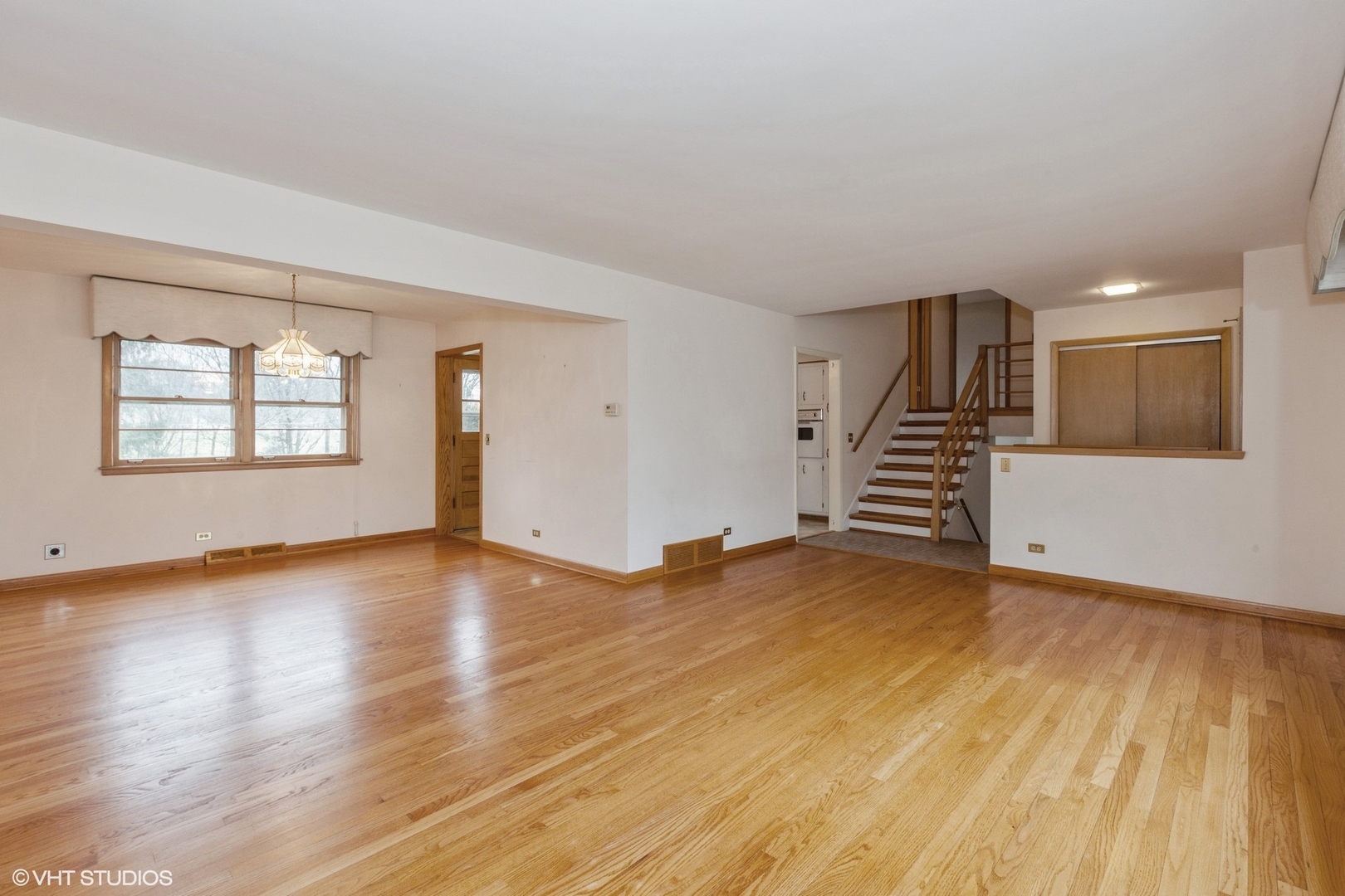 1330 South Main Street Wheaton, IL 60189 - Photo 4 of 19 an empty room with wooden floor and windows