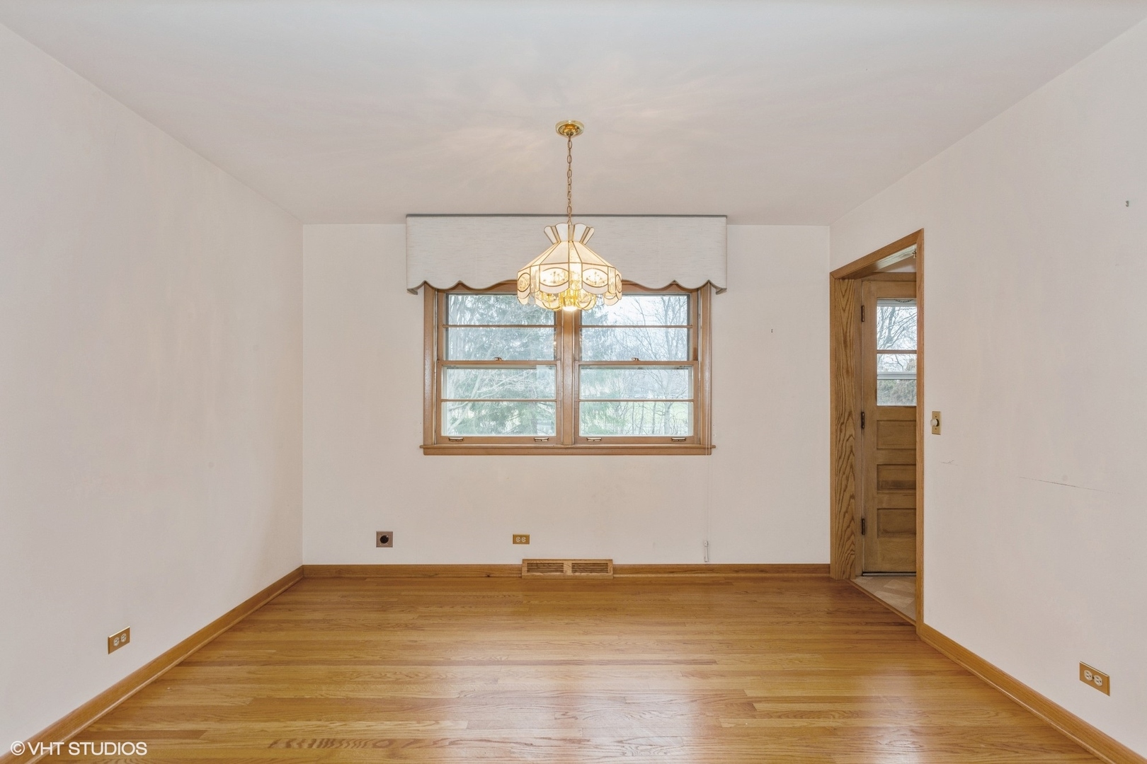 1330 South Main Street Wheaton, IL 60189 - Photo 5 of 19 a view of an empty room with chandelier fan and wooden floor