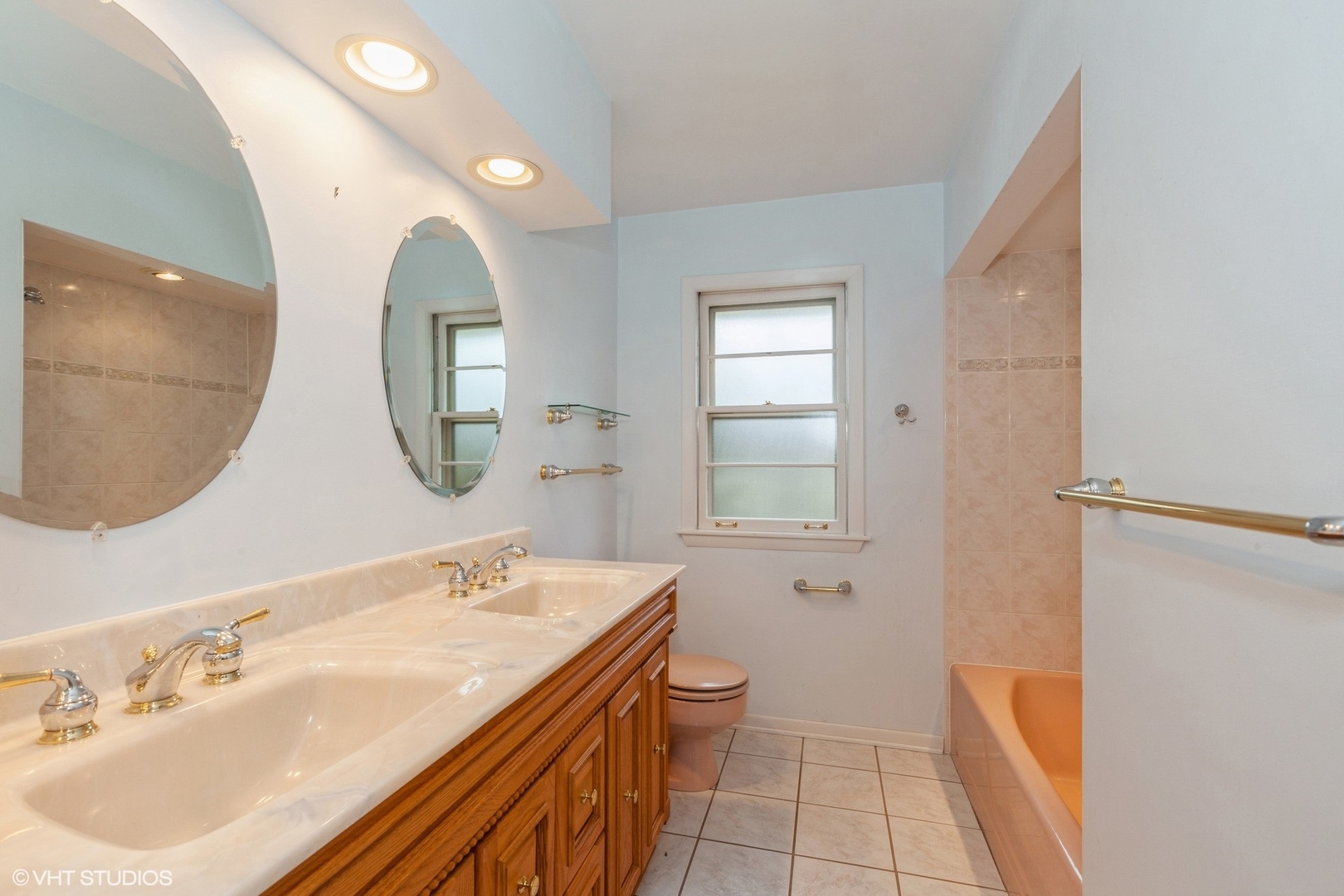 1330 South Main Street Wheaton, IL 60189 - Photo 10 of 19 a spacious bathroom with a double vanity sink a mirror and a bathtub
