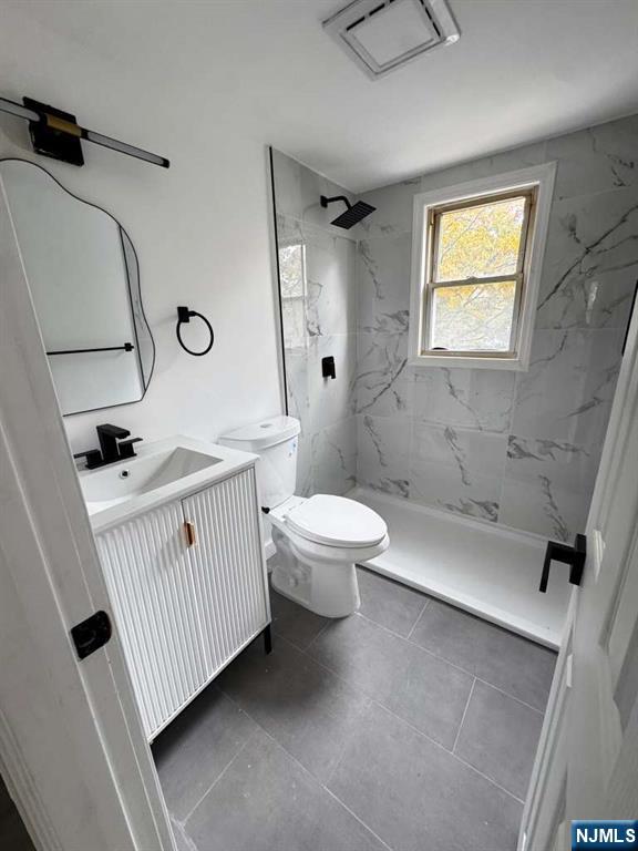 1417 Nelden Road Teaneck, NJ 07666 - Photo 11 of 12 a bathroom with a sink a toilet and shower