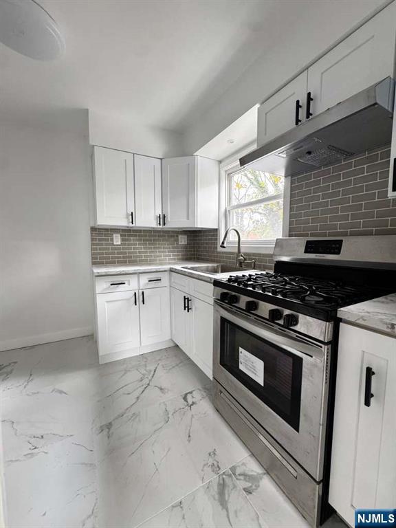 1417 Nelden Road Teaneck, NJ 07666 - Photo 12 of 12 a kitchen with a stove a sink and a window