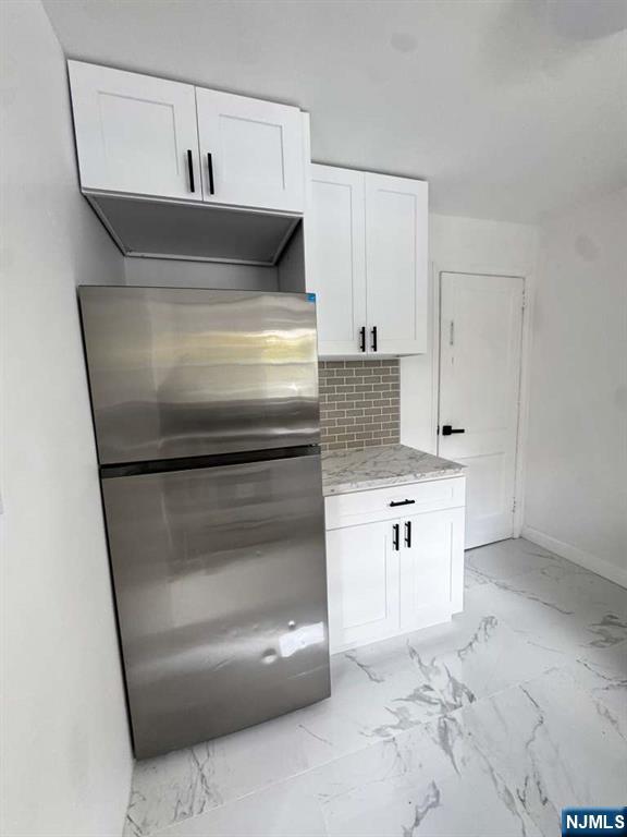 1417 Nelden Road Teaneck, NJ 07666 - Photo 2 of 12 a kitchen with white cabinets and stainless steel appliances