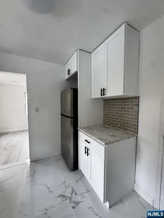 a kitchen with a stove refrigerator and microwave