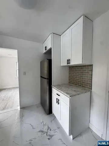 a kitchen with a stove refrigerator and microwave
