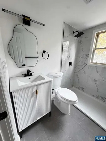 a bathroom with a toilet sink and shower