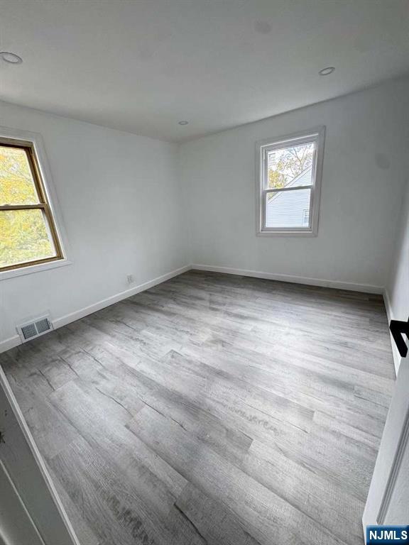 1417 Nelden Road Teaneck, NJ 07666 - Photo 9 of 12 a view of an empty room with wooden floor and a window