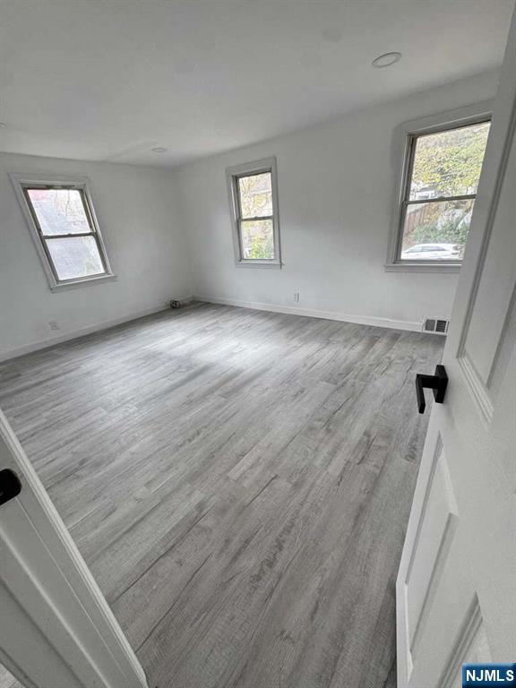 1417 Nelden Road Teaneck, NJ 07666 - Photo 10 of 12 wooden floor in an empty room with a window