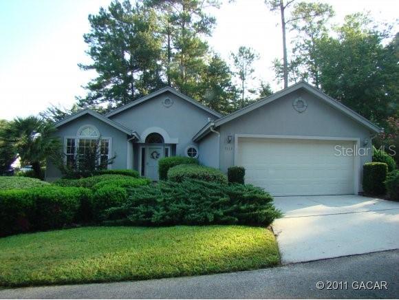 5113 Southwest 88 Terrace Gainesville, FL 32608 - Photo 1 of 1 a front view of a house with garden