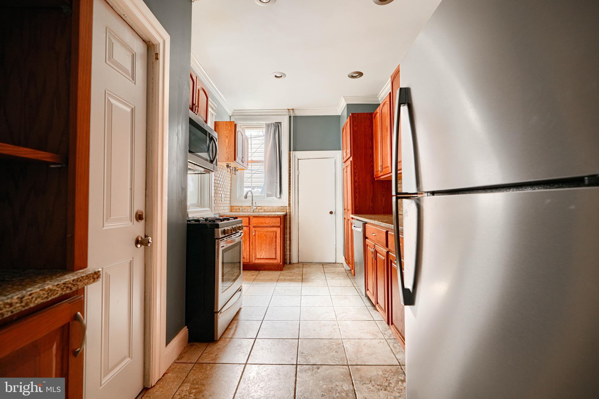 216 South High Street Baltimore, MD 21202 - Photo 11 of 25 a view of a kitchen with a refrigerator