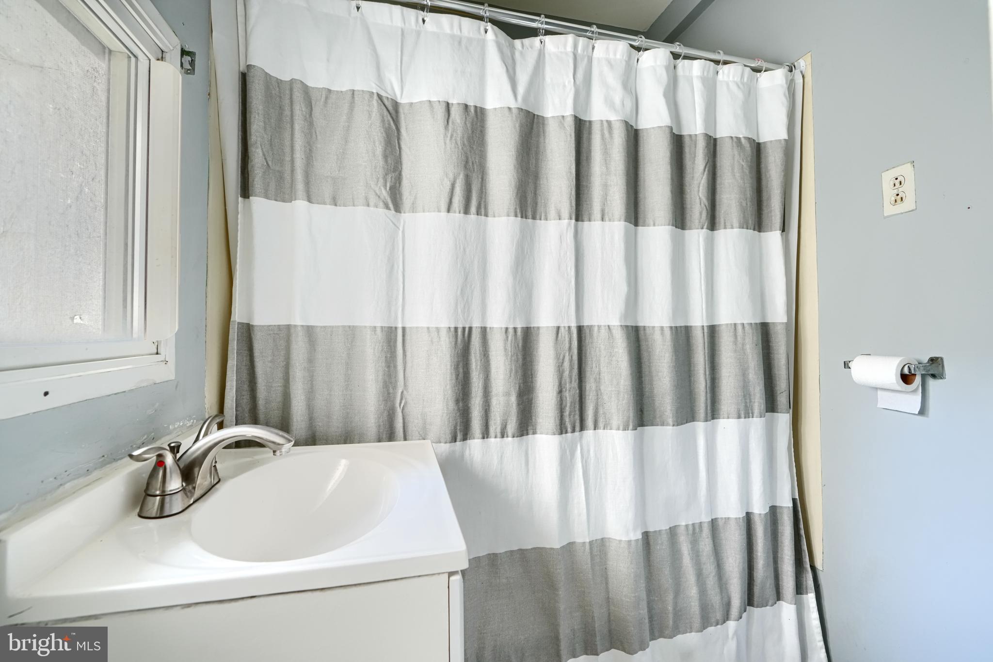 216 South High Street Baltimore, MD 21202 - Photo 18 of 25 a bathroom with a sink and a mirror