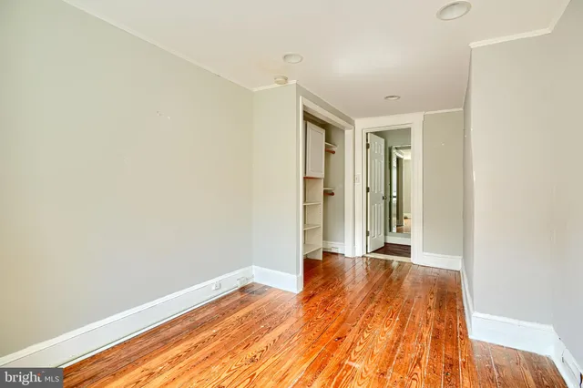 a view of hallway with wooden floor