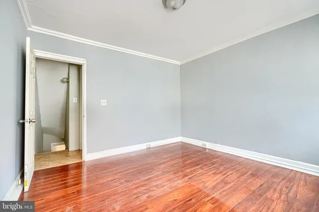 a view of a utility room with wooden floor