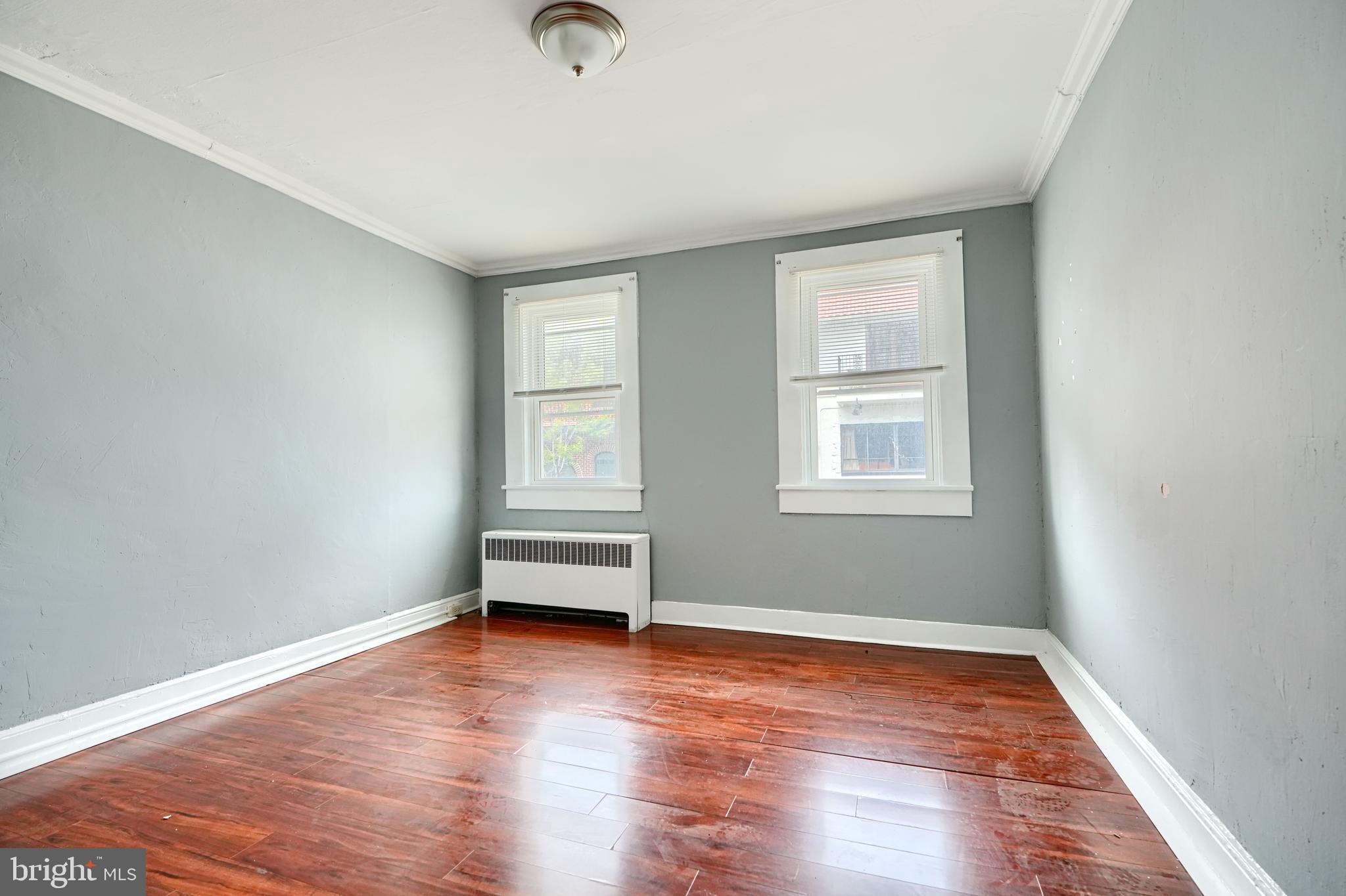 216 South High Street Baltimore, MD 21202 - Photo 7 of 25 an empty room with wooden floor and windows