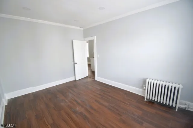 a view of a room with wooden floor and fence