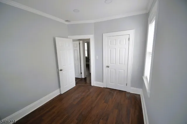 an empty room with wooden floor