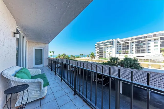a view of a balcony with chair and wooden floor