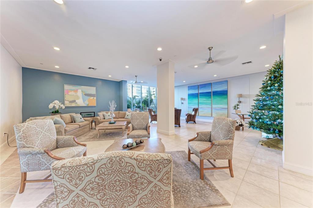 1212 Benjamin Franklin Drive, Unit 208 Sarasota, FL 34236 - Photo 22 of 32 a living room with furniture and a potted plant