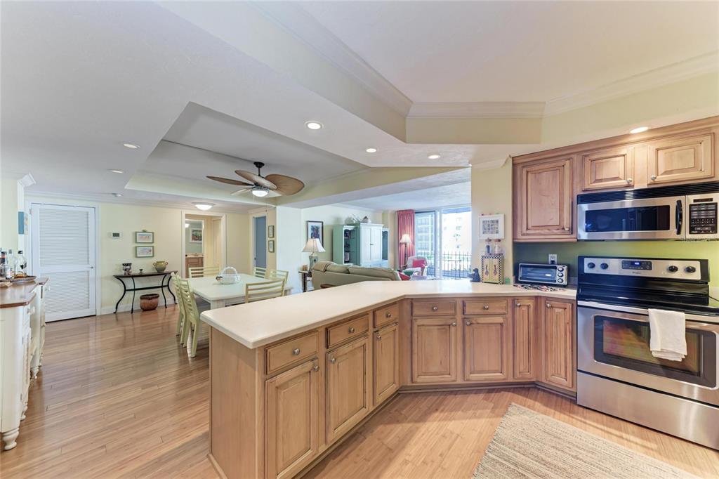 1212 Benjamin Franklin Drive, Unit 208 Sarasota, FL 34236 - Photo 9 of 32 a large kitchen with stainless steel appliances granite countertop a lot of counter space and wooden floors