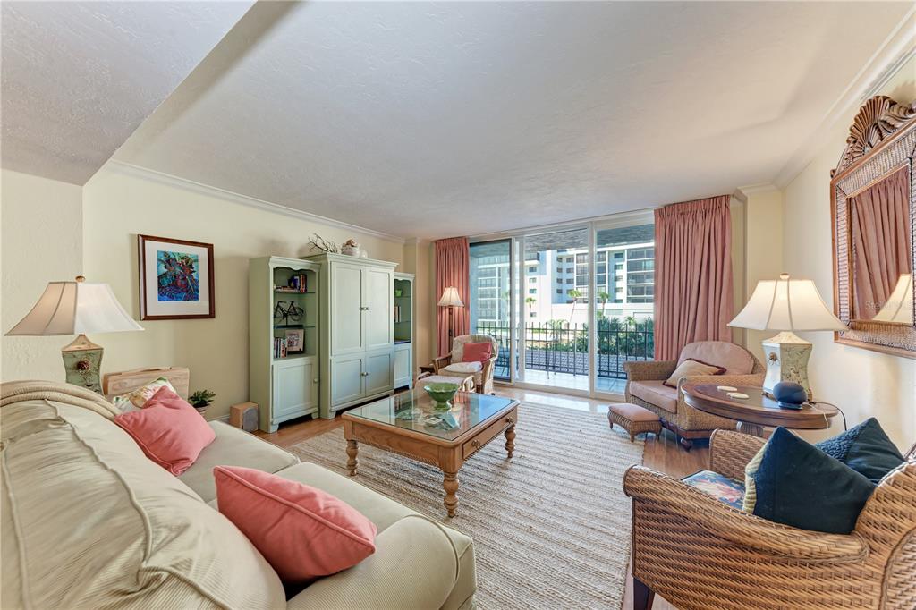 1212 Benjamin Franklin Drive, Unit 208 Sarasota, FL 34236 - Photo 10 of 32 a living room with furniture and a large window