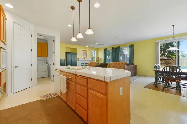 a view of a kitchen counter space dining table and chairs