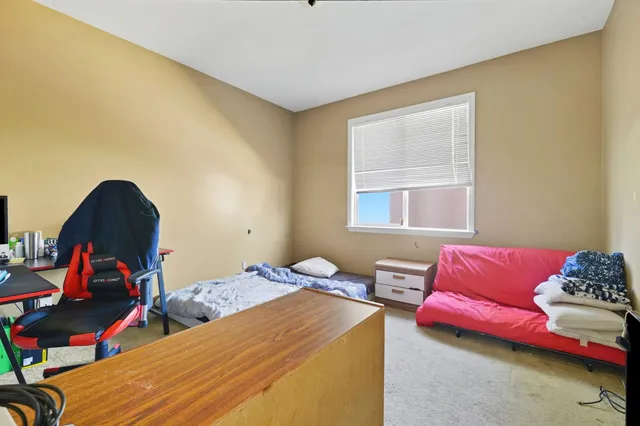 a bedroom with furniture and a window