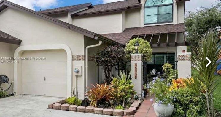 a view of a house with potted plants