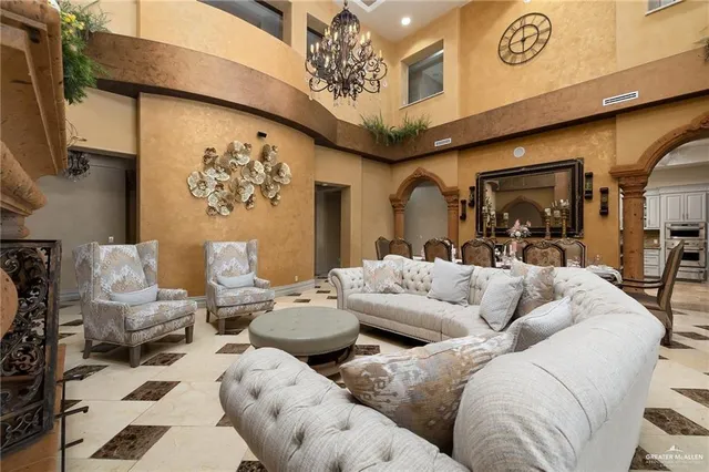a living room with furniture and a chandelier