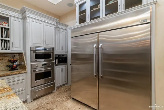 a kitchen with a refrigerator and cabinets